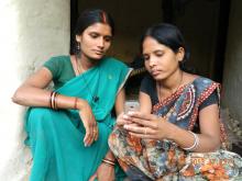 An ASHA uses a CommCare app on mobile phone to counsel her pregnant client. Src - Satish Srivastava/Catholic Relief Services. 